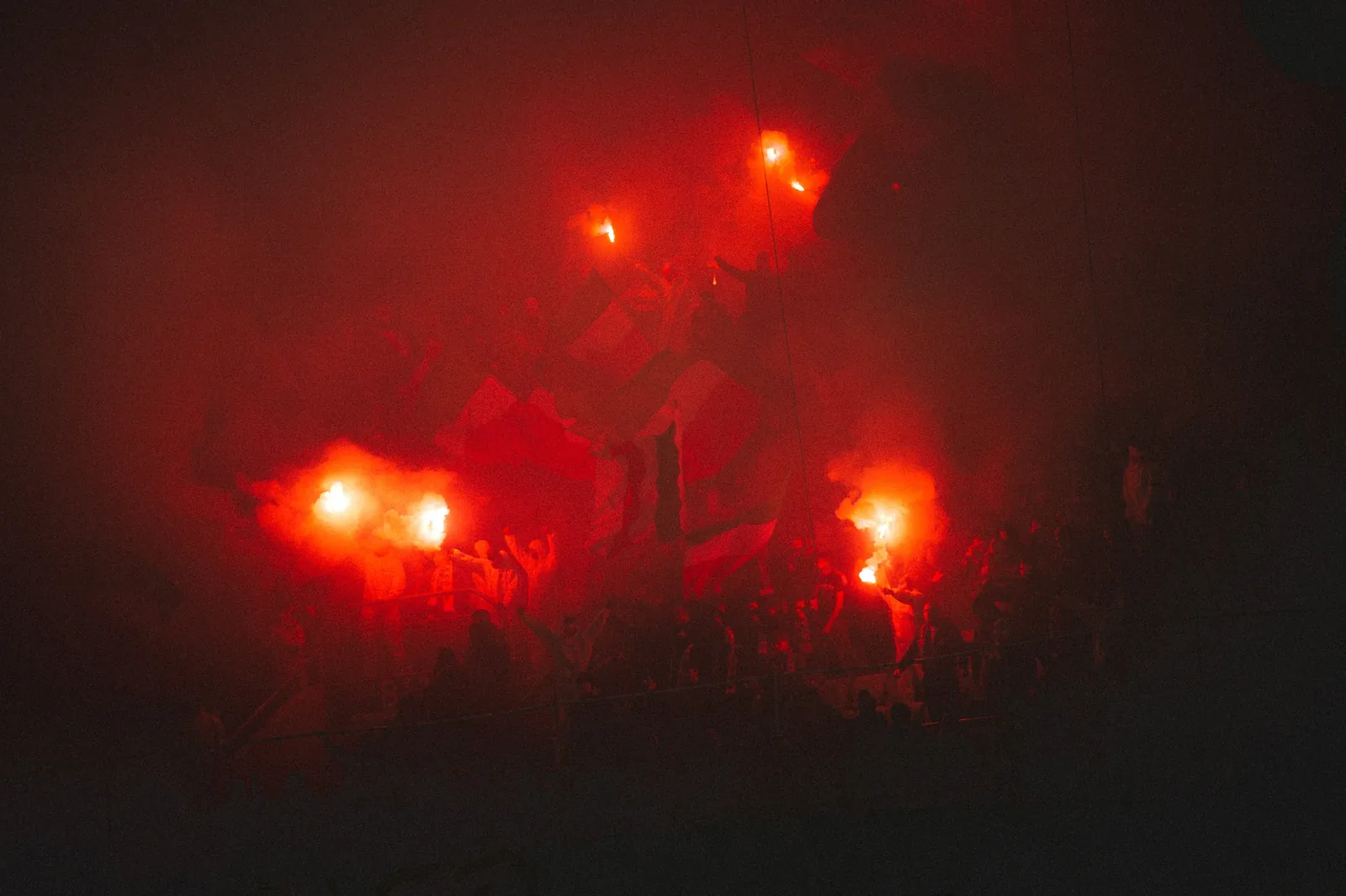 Flares in the smoke. Exposed for the fire, the stand stays in shadow.