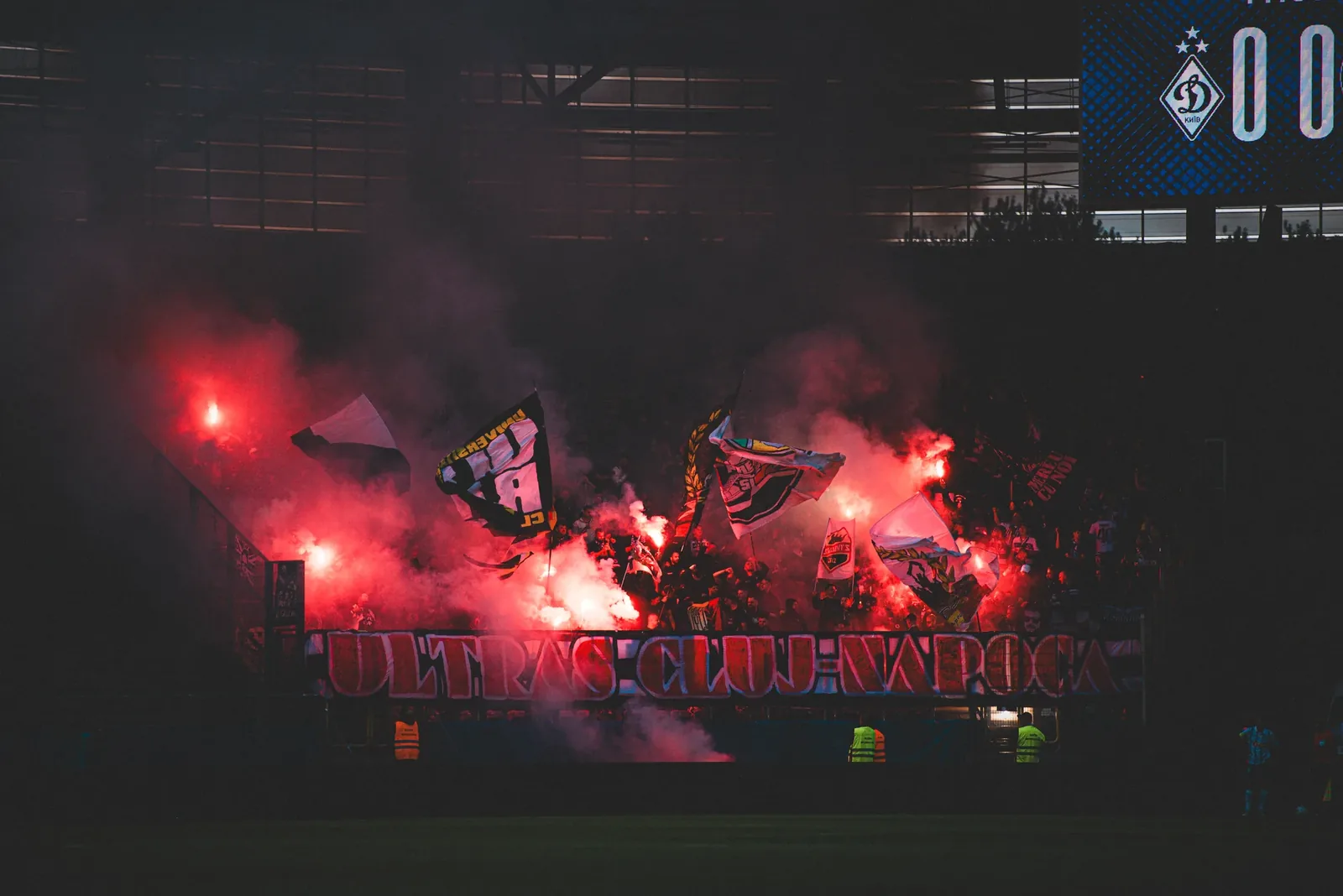 A display across the whole stand: flares, flags and a banner in one frame.